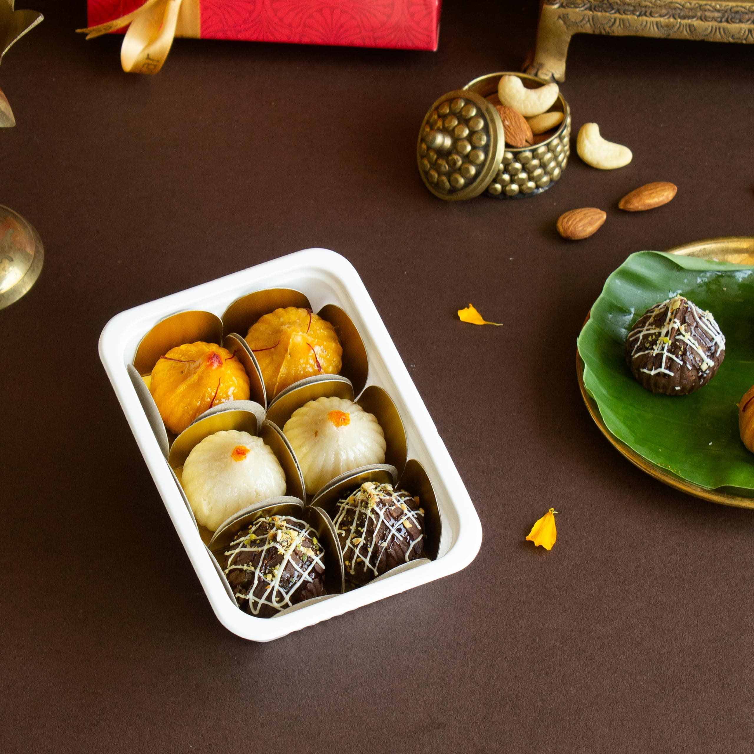 Dessert Drama Present Diffrent Diffrent Flover Laddo,Perfectly packed 2 pc Shahi Badam Modak, 2 pc Chocolate Modak and 2 pc Kaju Kesar Modak in Kesar Evergreen Box